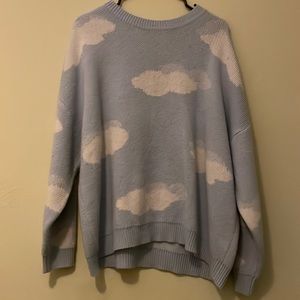 It’s an medium oversized blue knitted sweatshirt with clouds.